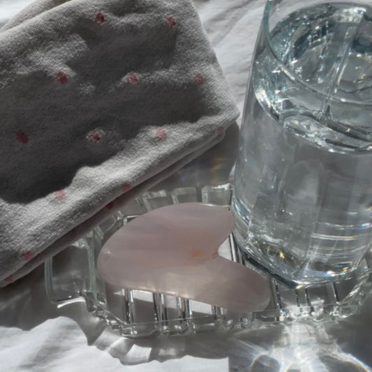 glass of water behind a heart shape design